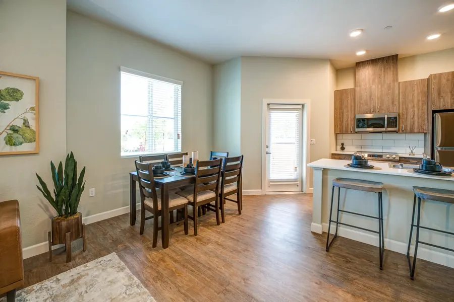 Apartment kitchen and dining table beside a large window