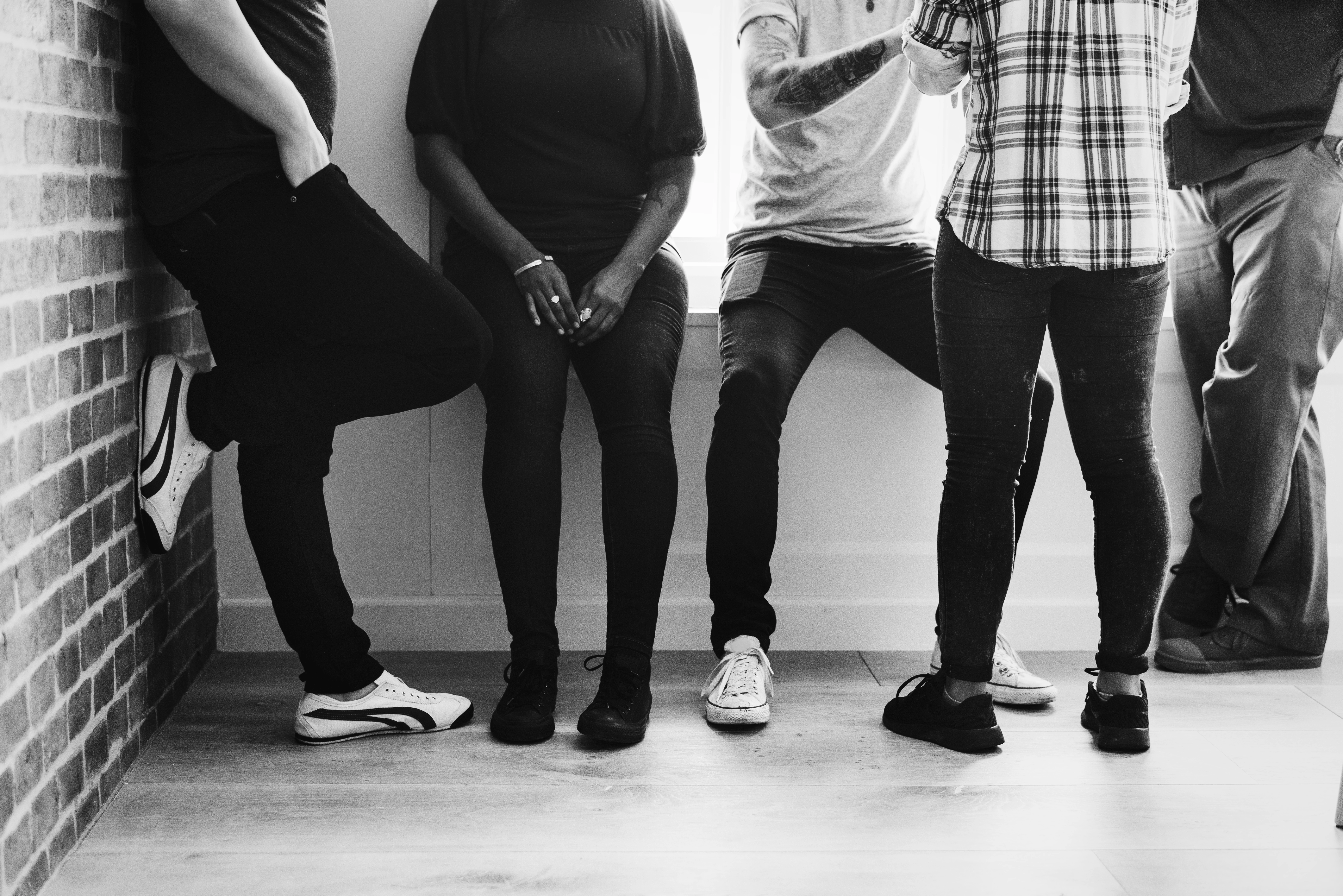 Young adults raising their hands in worship during The Gathering at New Hope Church.