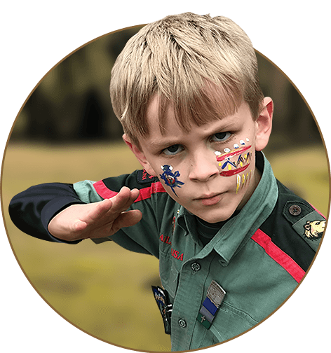 Boys in Trail Life USA Troop 4620 learning survival skills in a camping activity.